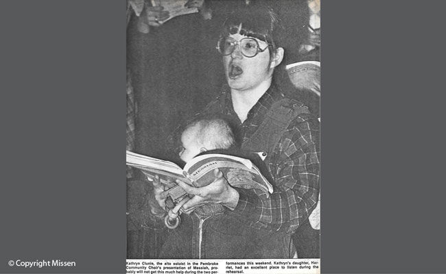 Baby Harriet gets a front-row seat as Kathryn sings a solo in a community concert, Eganville, Ontario, 1985